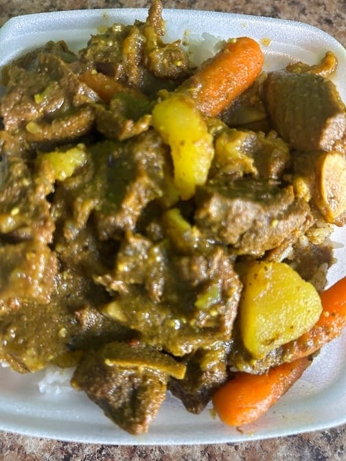 Curry Goat Small Served with White Rice or Rice & Peas.